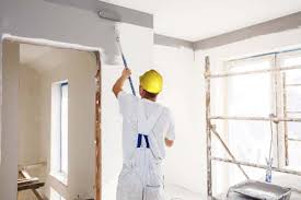 Painter applying paint to an interior wall